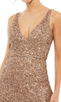 A person wears the Short Homecoming Dress 4971 by Mac Duggal, a sleeveless V-neck gold sequin dress with beaded fringe. The image is cropped at the neck and below the hips.