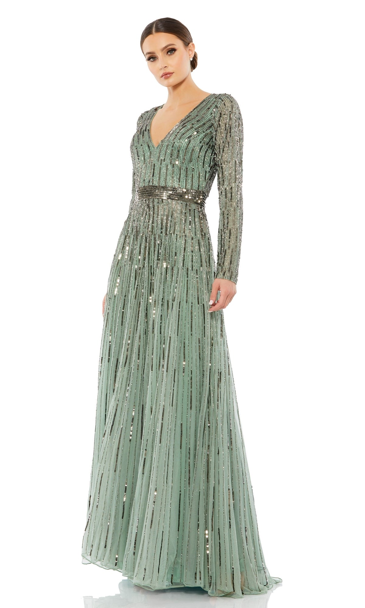 A woman stands against a plain white background, wearing the Long Formal Dress 4977 by Mac Duggal—a long, sage green sequin a-line dress with long sleeves and a v-neckline.