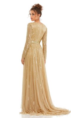 A woman faces away, wearing the Long Formal Dress 4977 by Mac Duggal—a floor-length, long-sleeved gold sequin A-line gown with vertical embellishments and a cinched waist.
