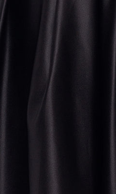 Close-up of smooth, black satin fabric with soft folds and a slight sheen on the Sheer-Bodice Short Black Hoco Dress 4982BN, perfect for an elegant corset-style look.