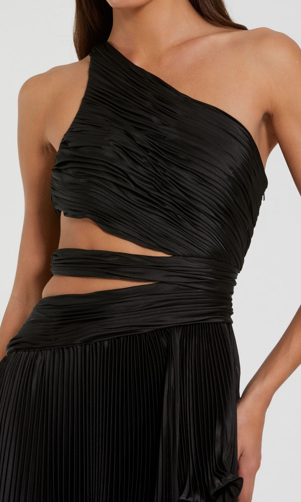 Woman wears a Mac Duggal 49837 High-Low Pleated Formal Dress with a one-shoulder design, waist cutout, and ruched detailing.