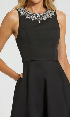 Woman wearing the Mac Duggal 49844 High-Low Formal Dress, featuring a fitted bodice, embellished neckline, and elegant sleeveless design.