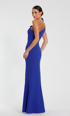A woman models the Mac Duggal 49862 One-Shoulder Long Formal Dress, showcasing its fitted, floor-length design against a plain white background.