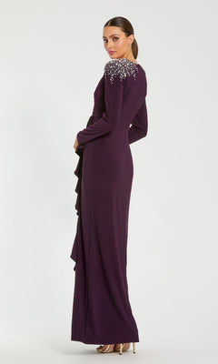 Woman wearing the Amethyst Purple Formal Gown (Mac Duggal 49897) with ruffle details and embellished shoulders, standing in profile against a white background.