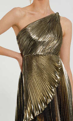 Someone wearing the Mac Duggal 49910 Gold Pleated Prom Dress, featuring a metallic gold finish, formal style, and asymmetrical one-shoulder design.