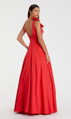 A woman stands against a white background wearing the Shoulder-Bow Long Formal Dress (Mac Duggal 49972): a floor-length, sleeveless red evening gown featuring an asymmetrical shoulder and elegant bow detail.