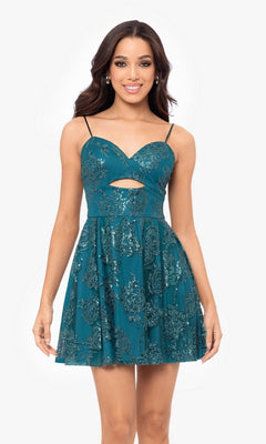 A woman wearing the Cut-Out Short Teal Glitter-Print Hoco Dress 4997BN, featuring thin straps, a front cutout, a flared skirt, and sequined floral patterns.