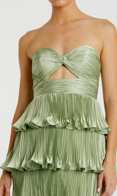 Someone in the Mac Duggal 49981 Long Formal Dress—a strapless, light green pleated gown featuring a twisted bodice, cutout accents, and tiered ruffled layers reminiscent of a column silhouette.
