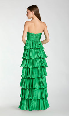 A woman faces away in the Long Formal Dress: Mac Duggal 49981, a strapless ruffle gown with tiered layers, set against a plain light background.
