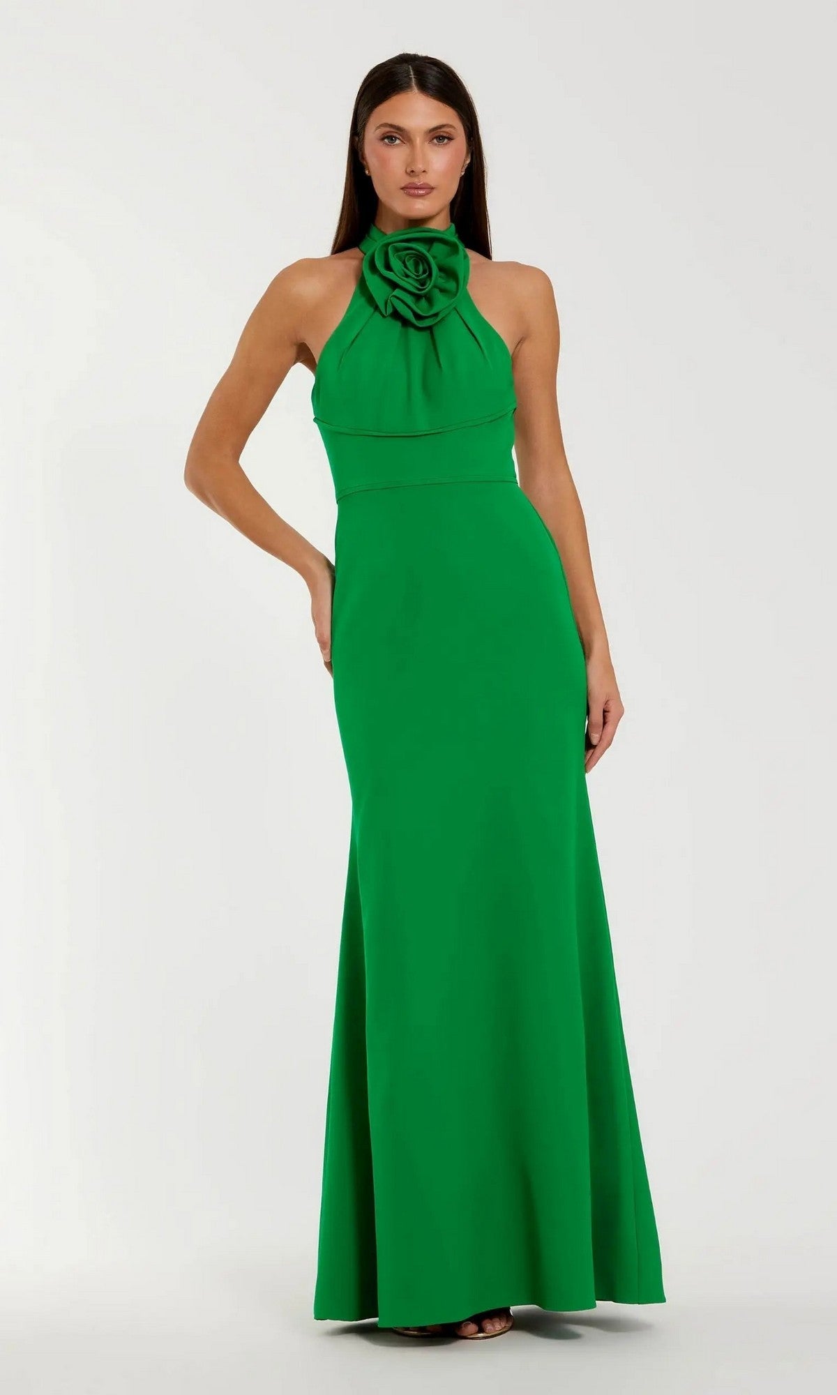 A woman wears the Mac Duggal 50053, a high-neck, floor-length blue formal dress, against a plain light background.