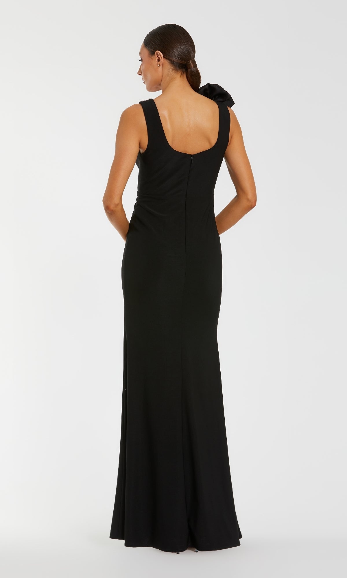 Woman wearing a black evening gown on a white background