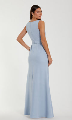 A woman stands facing away against a plain background, her head turned toward the camera, modeling the Mac Duggal 50097 Long Formal Dress—a sleeveless, floor-length crepe gown in light blue.