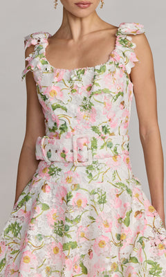 Woman wearing the Mac Duggal 50112 Midi Party Dress, featuring a sleeveless design with a belted waist, floral lace in pink and green hues, a square neckline, and ruffled shoulder straps—an ideal party dress for any occasion.