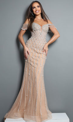 A woman, smiling with her hands on her hips, stands against a gray background wearing the Jovani 50202 Long Formal Dress in a nude hue. This off-the-shoulder evening gown features beaded embellishments and sheer accents, capturing elegance with its exquisite detailing and sophisticated silhouette.