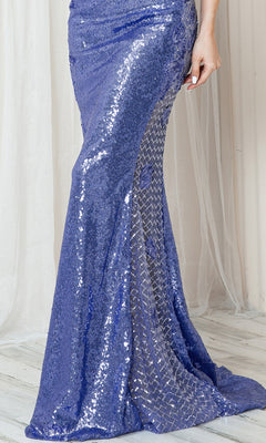 A person wearing the Corset-Back High-Neck Long Sequin Prom Dress 5043, featuring sheer patterned sections, stands on a light wooden floor with a sheer curtain in the background.