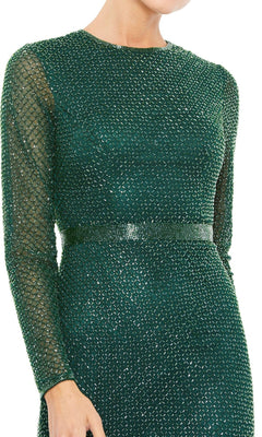 A person wearing the Long Formal Dress 5056 by Mac Duggal: a fitted, long-sleeve dark green dress featuring a textured diamond pattern and a subtle waistband detail.