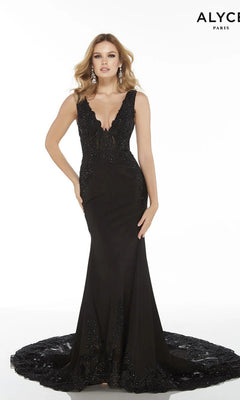 A woman poses against a white background in the Alyce 5065, a sleeveless black formal long dress featuring a lace-embellished bodice and deep V-neckline. The floor-length gown flows elegantly, showcasing its delicate detailing.