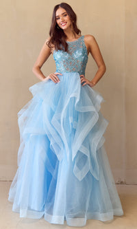 Woman wearing a light blue ball gown with a beaded top and a layered glitter tulle skirt against a beige background