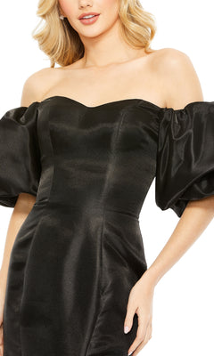 Woman shown from mid-torso up wearing the Mac Duggal 50677 Off-the-Shoulder Long Gala Gown in black, featuring puffed short sleeves and a formal design.