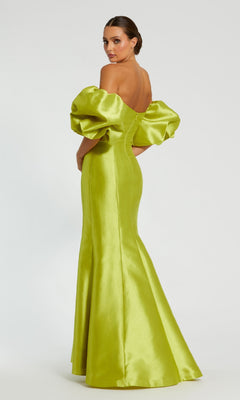 A woman poses against a plain background, wearing the Mac Duggal 50677 Off-the-Shoulder Long Gala Gown in shiny lime green with dramatic puff sleeves.