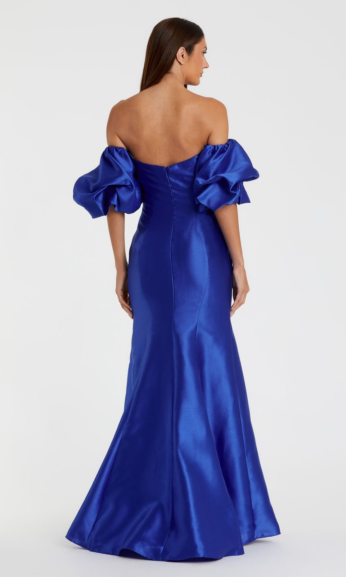 Woman shown from the back wearing the Off-the-Shoulder Long Gala Gown by Mac Duggal 50677, a royal blue, floor-length mermaid dress featuring puffed short sleeves and an off-the-shoulder design.