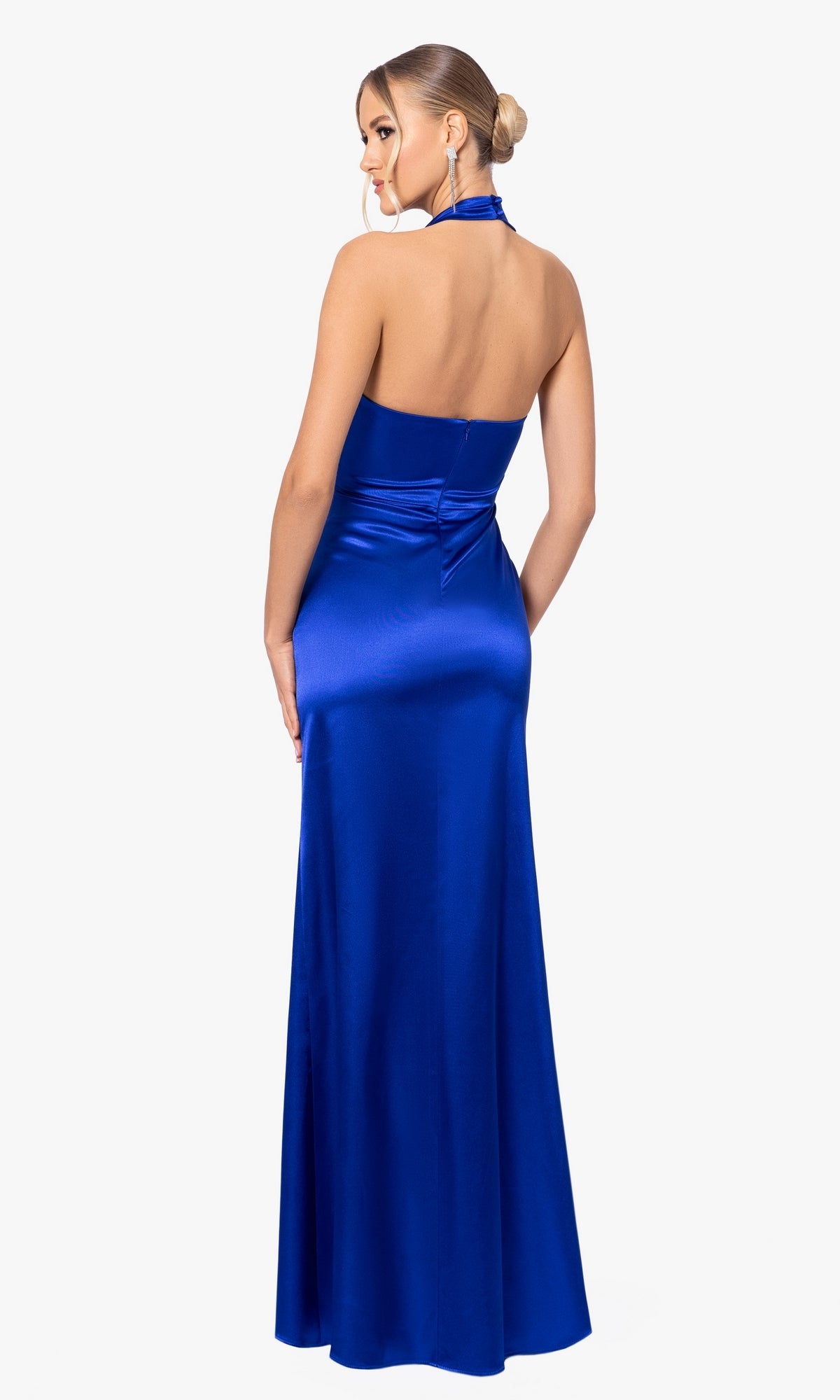 A woman is shown from the back wearing the Blondie Nites Long Prom Dress 5070BN—a sleeveless, floor-length royal blue halter dress with a satin finish and ruched detail—against a plain white background.