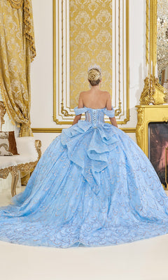 A woman wearing the Quinceanera Dress 5076 by Dancing Queen stands with her back to the camera in a lavish, gold-accented room.