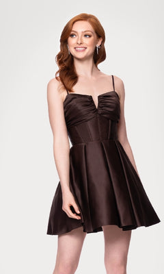 A woman with long red hair wears the Blondie Nites 5107BN Lace-Up Short Hoco Dress, featuring a sleeveless design with a fitted bodice and flared skirt, standing against a plain light background.