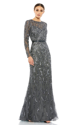 A woman models the Mac Duggal 5124 Long Sleeve Sequin Formal Dress, showcasing its fitted silhouette and intricate embellishments against a white background.