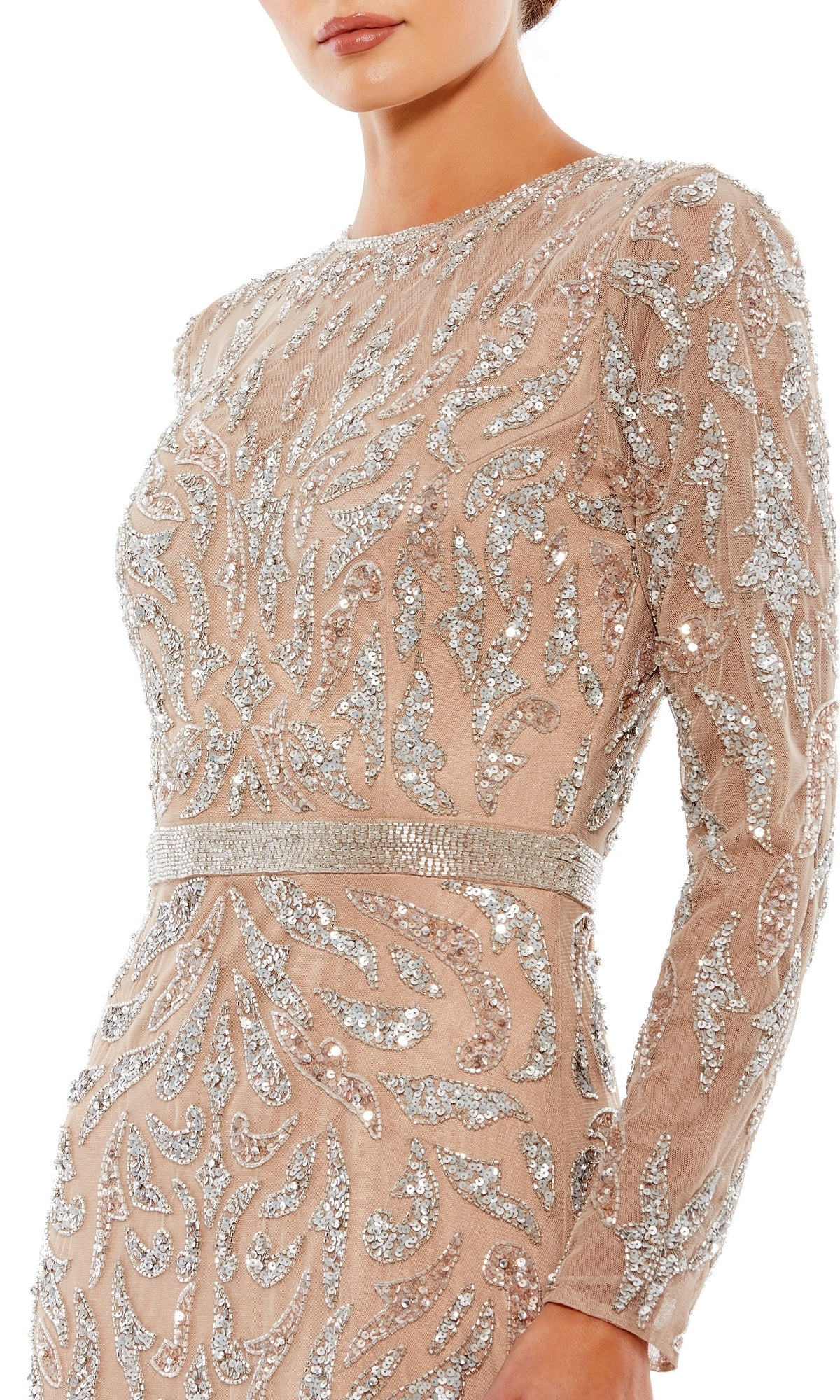 A woman wearing the Mac Duggal 5124 Long Sleeve Sequin Formal Dress—a nude dress with intricate silver sequin and bead embellishments in swirling patterns.