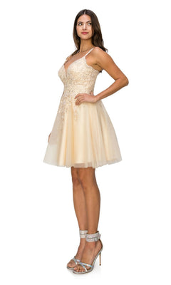 A woman stands in profile wearing the Corset-Back Short Glitter Homecoming Dress 5125J, featuring a fitted bodice and embellished details, styled as an elegant semi-formal look with silver high-heeled sandals.