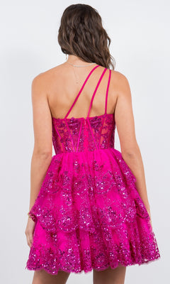 A woman is shown from behind wearing the One-Shoulder Short Tiered Homecoming Dress 5132J, a bright pink sequin mini dress with strappy back and tiered skirt, against a plain background.