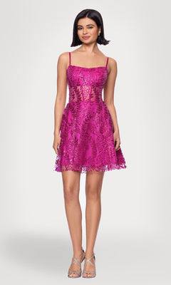 A woman models the Short Glitter Hoco Dress: Blondie Nites 5153BN, a bright pink sleeveless A-line party dress with sequin details and spaghetti straps, paired with silver high-heeled sandals against a plain background.