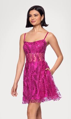 A woman models the Short Glitter Hoco Dress: Blondie Nites 5153BN—a sleeveless, bright pink cocktail dress with sheer panels and sequin accents—against a plain light background.