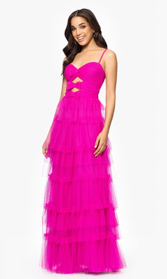 A woman smiles against a plain white background in the Long Hot Pink Prom Dress: Blondie Nites 5187BN, featuring a tiered tulle skirt, ruched sweetheart bodice, and cutout details.
