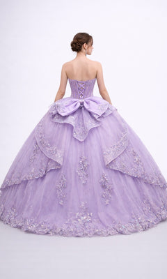 A woman is seen from the back against a plain white background wearing the Quinceanera Dress 5188 by Dancing Queen, which features a strapless corset bodice adorned with lace and beading, a large bow accent, and a voluminous ballgown skirt.