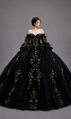 A woman wearing the Quinceanera Dress 5190 by Dancing Queen in black, featuring intricate gold leaf appliques and sheer sleeves, poses against a plain gray background—a stunning choice for a truly memorable celebration.