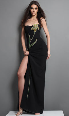 A woman in the Jovani 51902 long formal dress—an elegant black strapless gown featuring a thigh-high slit and green beaded embellishments—poses gracefully against a gray background.