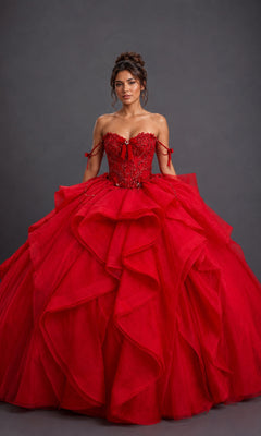 A woman poses against a plain dark background wearing the Quinceanera Dress 5197 by Dancing Queen in red, featuring a dramatic off-the-shoulder design with a beaded corset bodice and a layered tulle ball gown skirt.