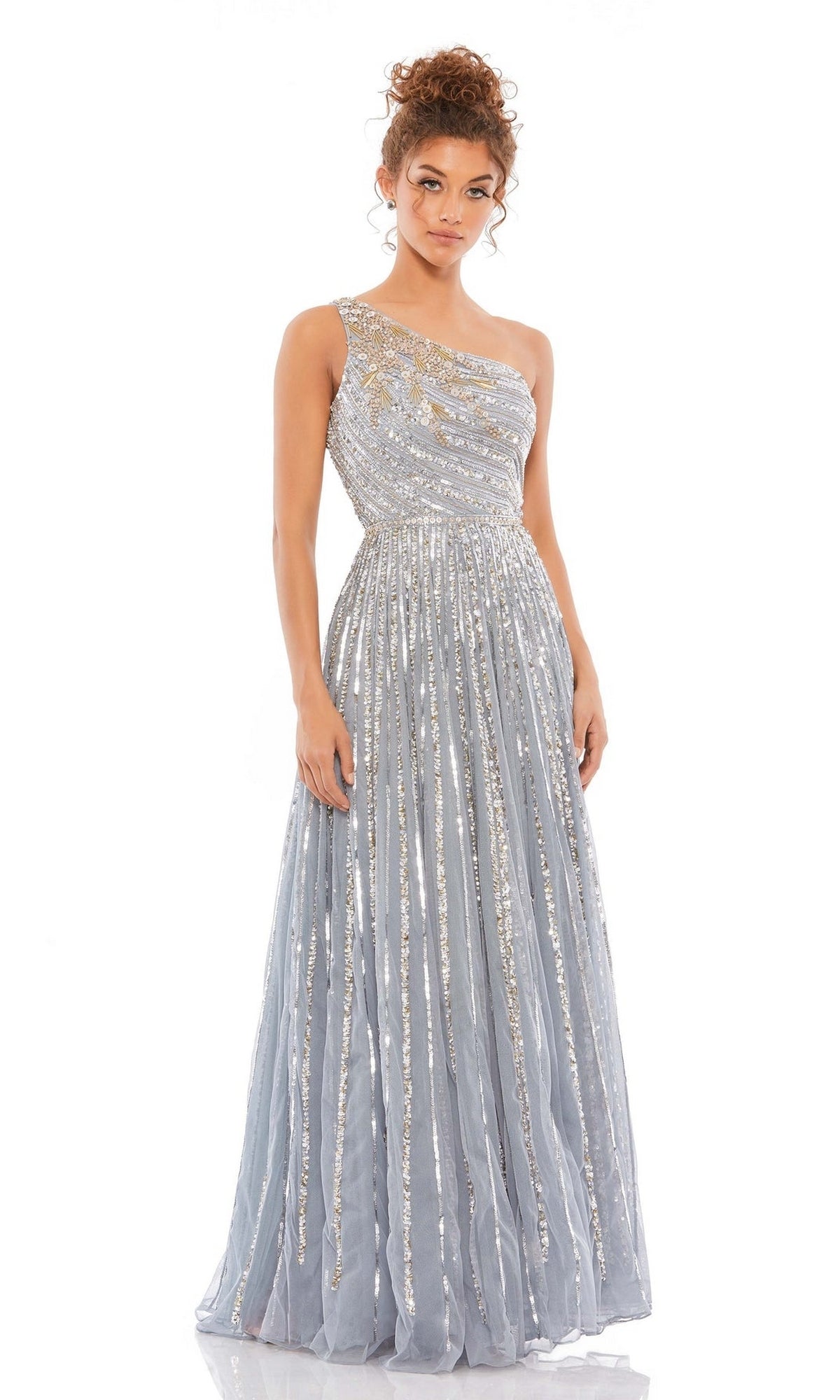A woman models the Mac Duggal 5220 One-Shoulder Beaded Formal Dress, showcasing vertical sequin embellishments and a long A-line evening gown silhouette against a white background.