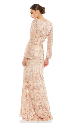 A woman models the Long Formal Dress 5222 by Mac Duggal— a light pink, long-sleeved, floor-length beaded gown with a fitted silhouette—posing with her back slightly turned against a white background.