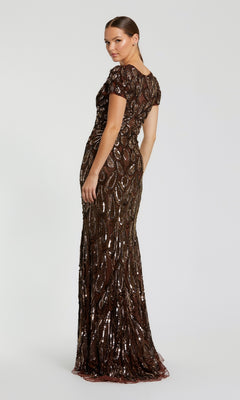 Woman wearing a long, dark sequined dress on a white background
