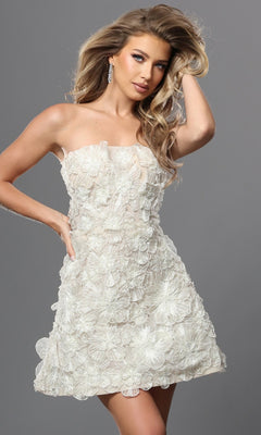 A woman stands against a gray background, effortlessly elegant with one hand in her hair, wearing the Jovani 52558 short ivory homecoming dress, a strapless design adorned with 3D petal appliques.