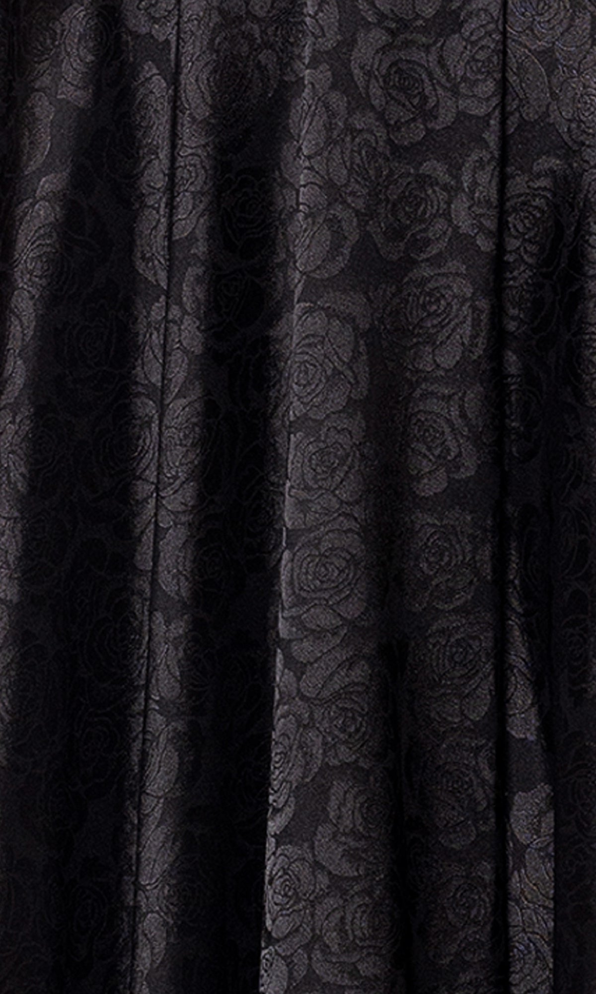Close-up of black fabric with a subtle rose floral pattern and slight folds, ideal for the Strapless Black Prom Gown: Blondie Nites 5301BN—perfect for an elegant junior-sized evening or prom look.