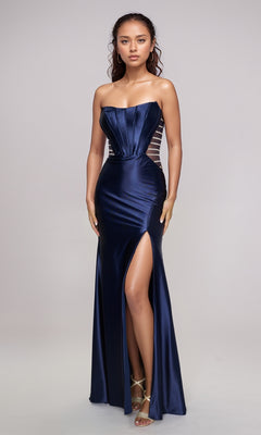 A woman wears the Nina Canacci 5307, a navy blue strapless satin formal dress with a fitted silhouette, sheer side panels, and a thigh-high slit, styled with strappy heels.