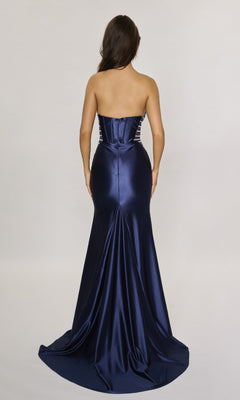 A woman is shown from the back wearing the Nina Canacci 5307 long formal dress—a strapless, fitted satin gown in navy that flows floor-length against a plain light background.
