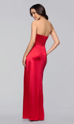 A woman stands against a plain gray background, looking over her shoulder while wearing the Blondie Nites 5355BN long strapless satin prom dress with a sweetheart neckline and floor-length red gown.