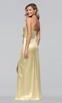 A woman models the Blondie Nites 5355BN long prom dress, featuring a strapless satin design with a sweetheart neckline, as she stands smiling over her shoulder against a plain light gray background.