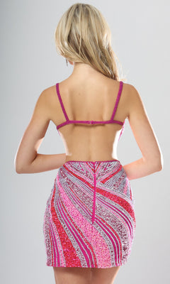 A woman with long blonde hair models the Jovani 53768 Short Homecoming Dress, a backless, fitted pink and purple sequined beaded dress featuring thin straps and a plunging v-neckline, photographed from behind against a plain gray background.