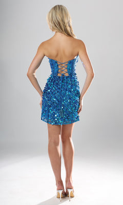 A woman stands with her back to the camera, showcasing the Jovani 53770 short homecoming dress—a blue strapless sequin dress featuring a corset bodice with lace-up open back detailing—paired with high heels, against a plain background.